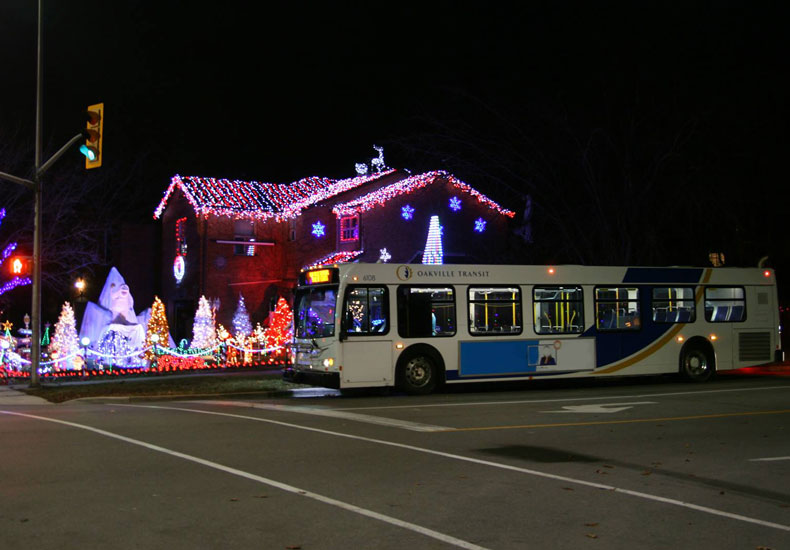 Transit bus with holiday lights in the background